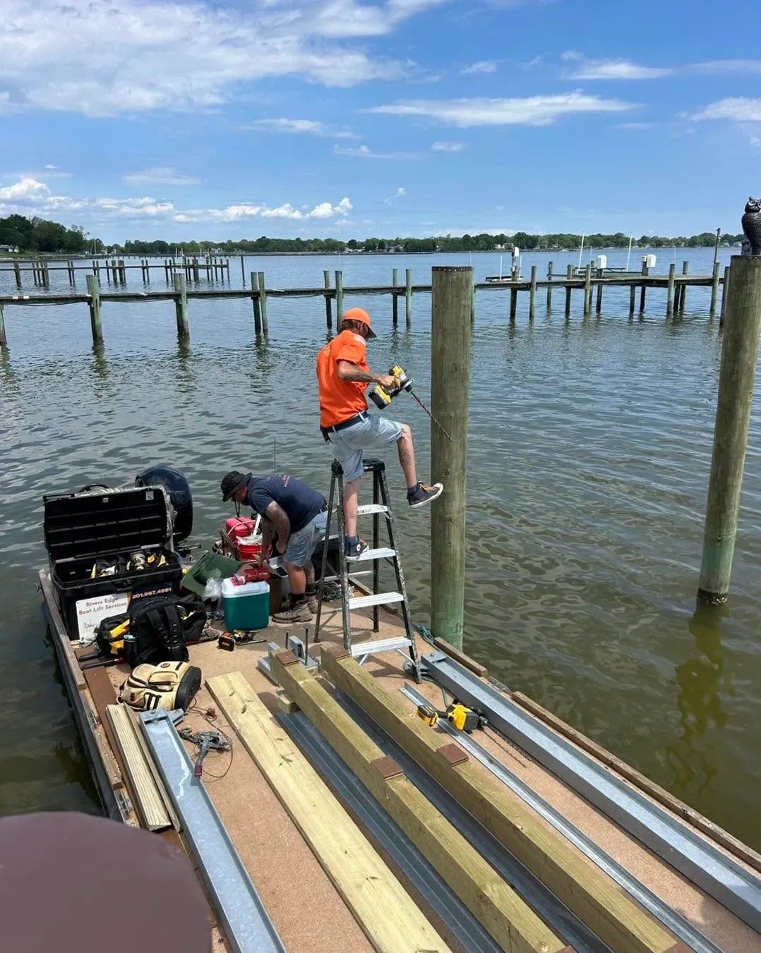 Crew working on a cradle at the end of a pier