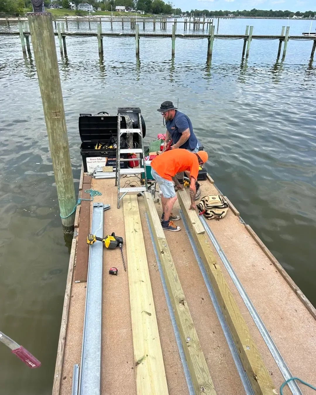 Crew assembling a cradle on a dock
