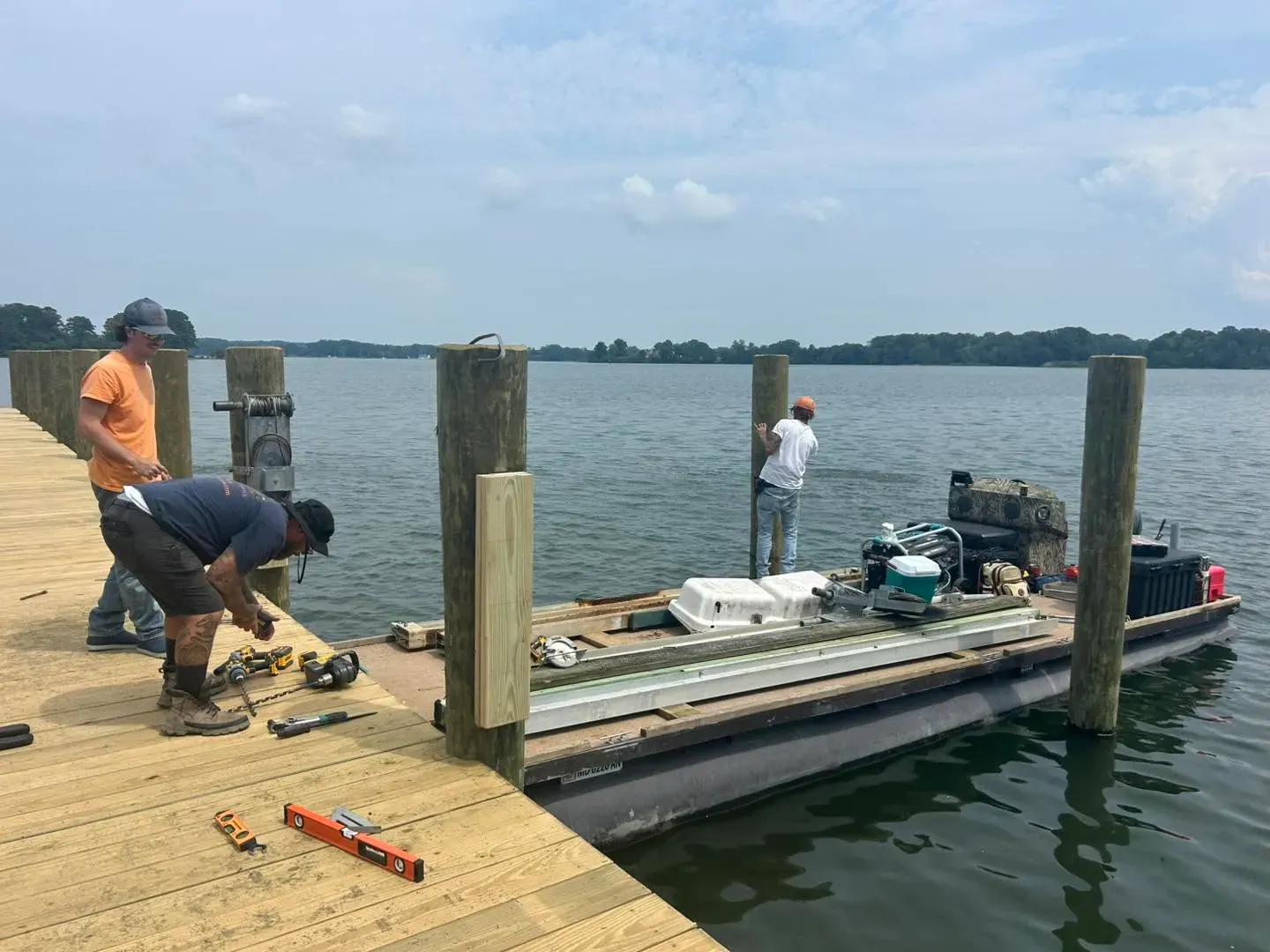 REBLS crew working on a lift from the dock and a workboat