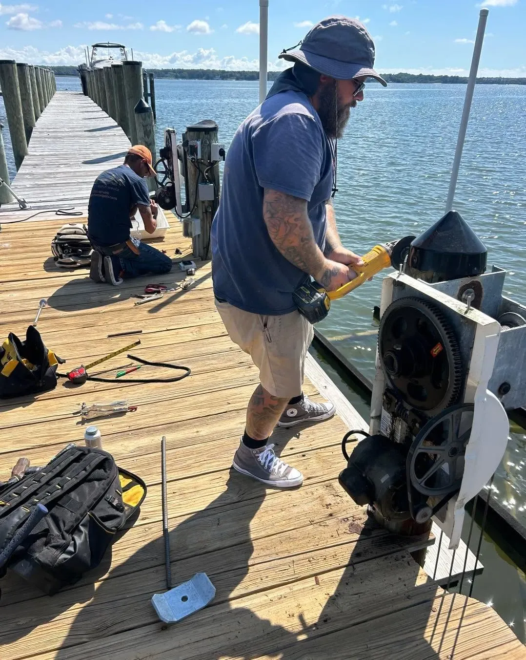 Boat lift motor and gearbox being serviced on a dock
