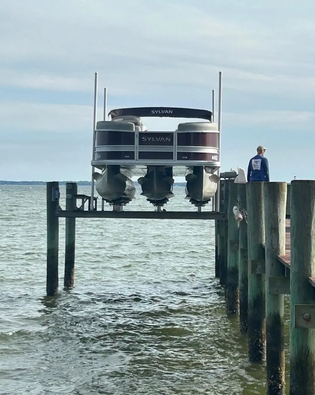 Tri-toon pontoon boat on a lift