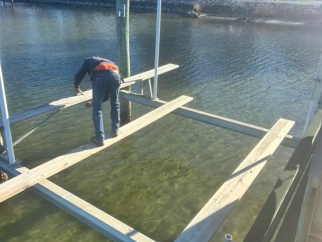 Technician standing in the water setting a cradle
