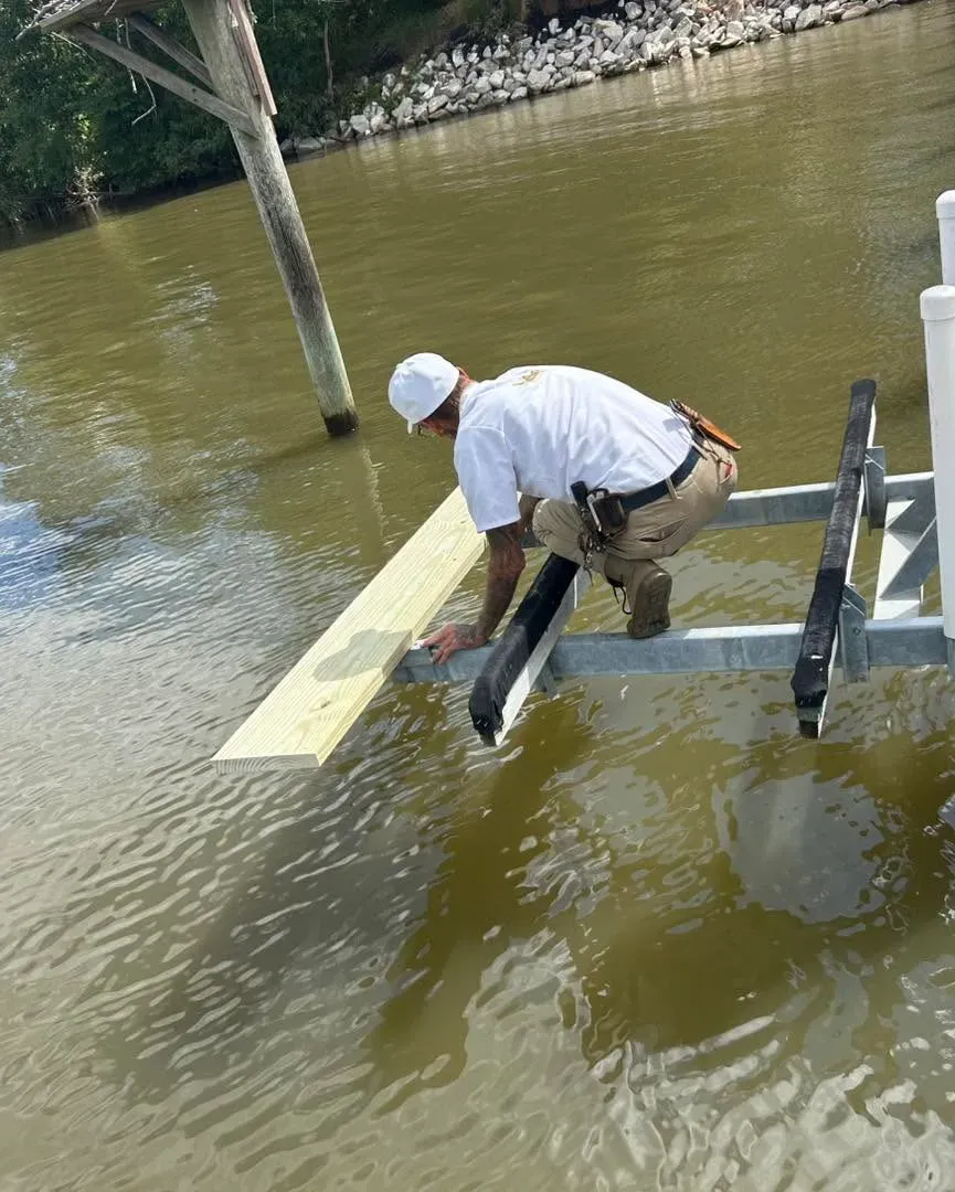 Technician setting a kayak lift in the water