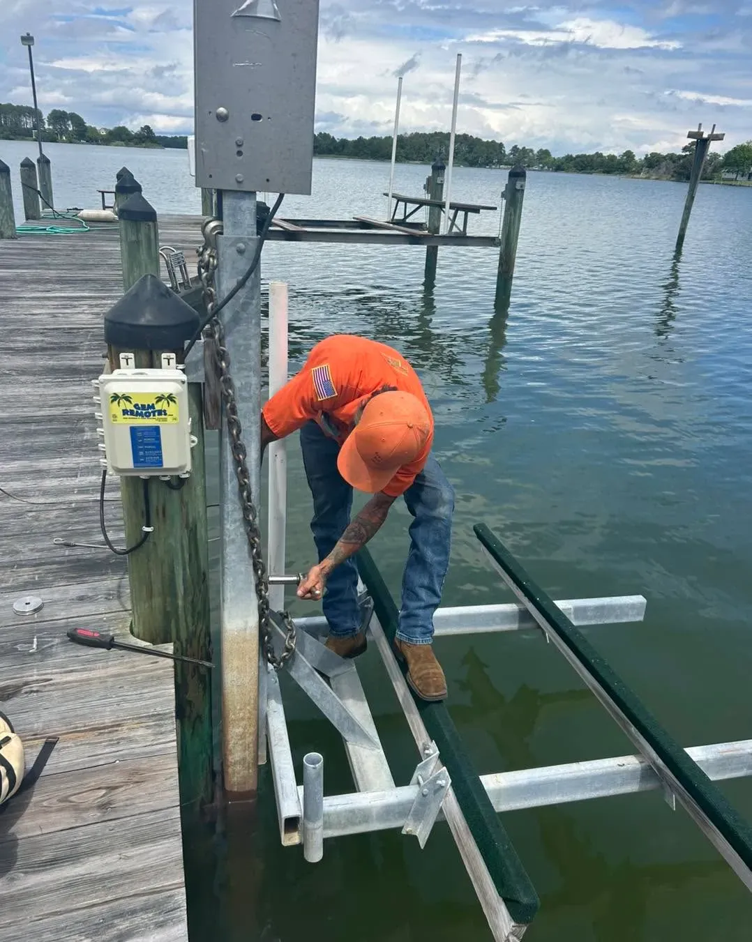 Technician at a lift control box on a piling